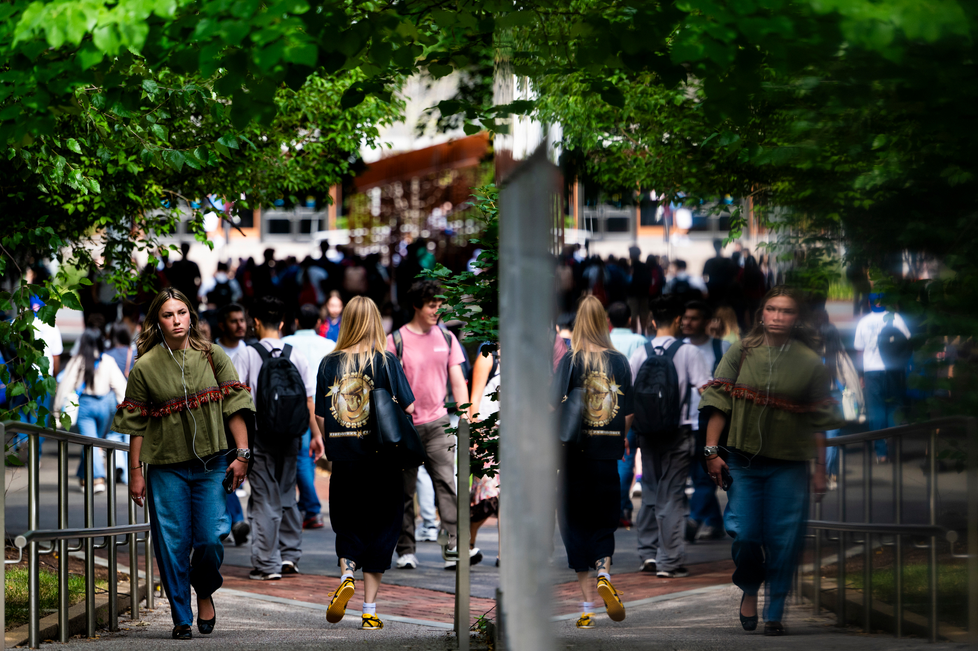 A crowd of students walks through Northeastern's Boston campus between classes.