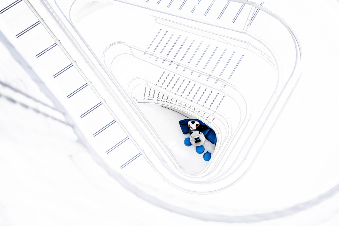A small robot figure sits on architectural blueprint paper on a desk inside the EXP building.