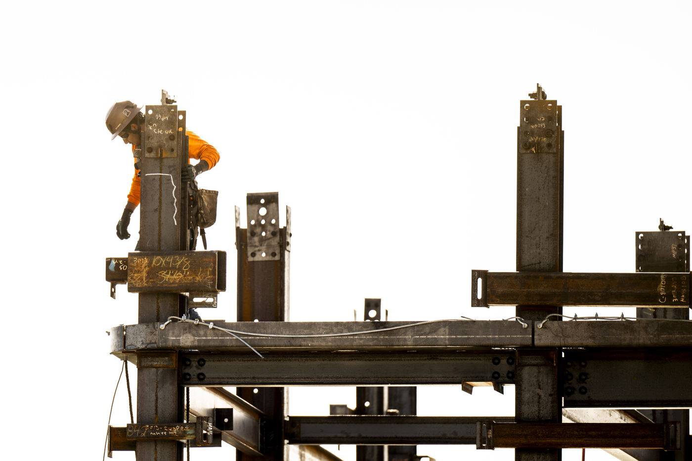 A construction worker climbs steel beams at the 840 Columbus Avenue residence hall construction site.