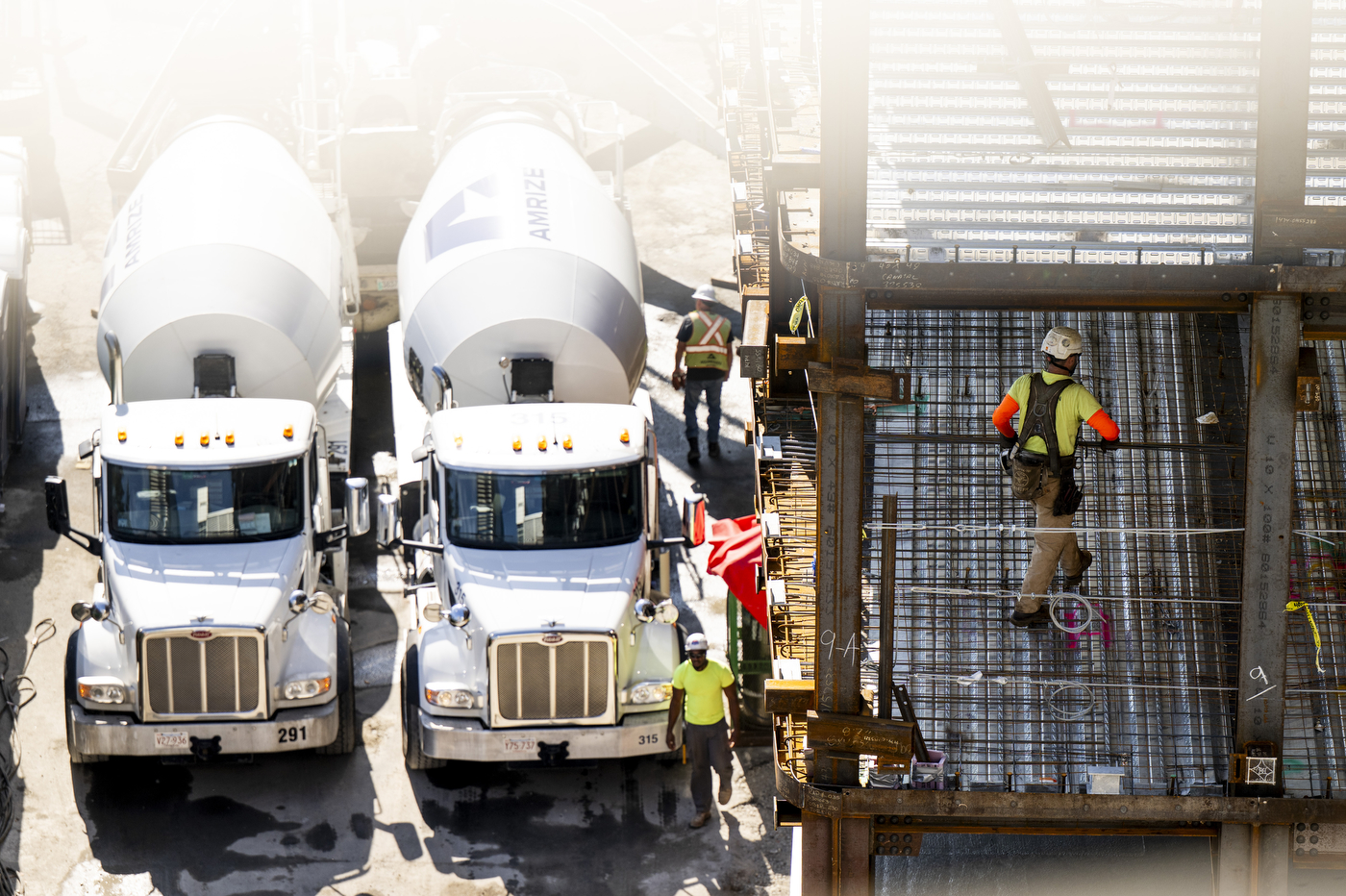 An aerial view shows cement trucks and workers near a rebar structure at the 840 Columbus Avenue construction site.