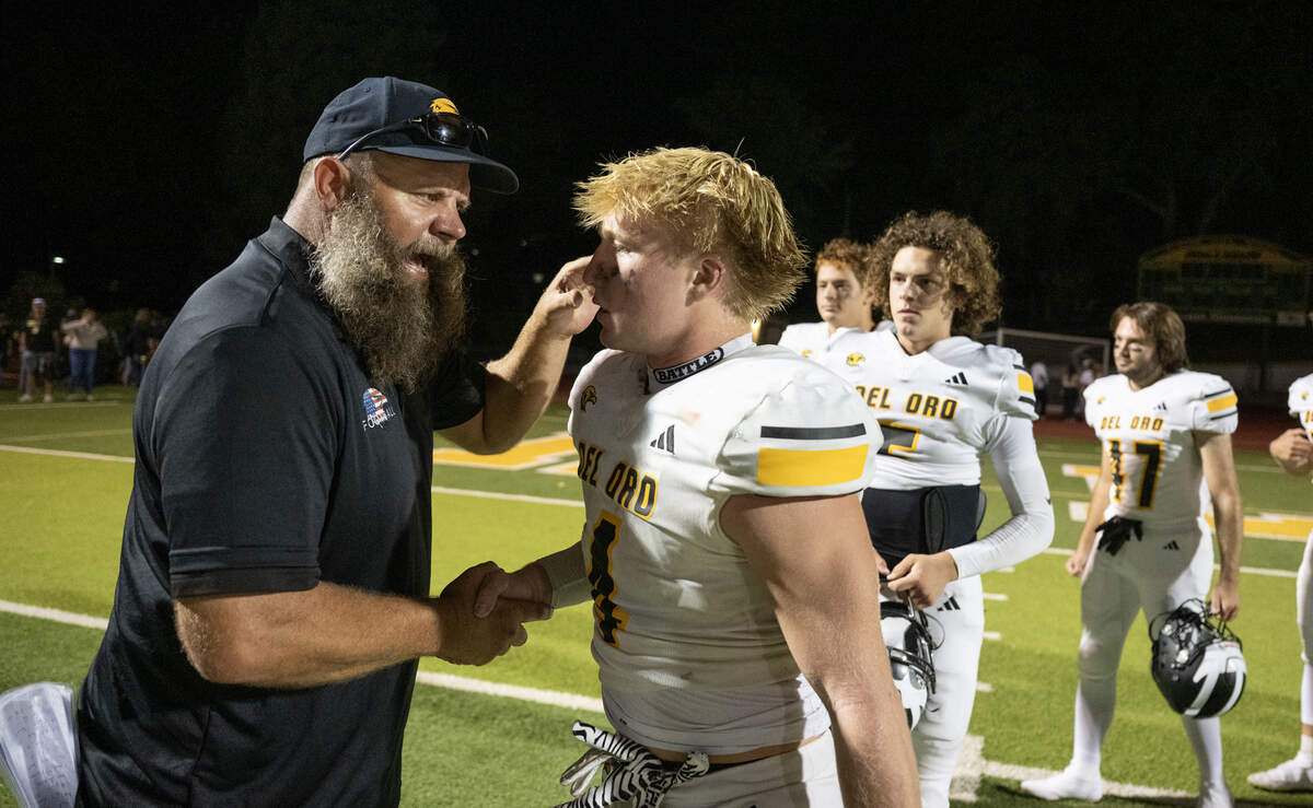 Del Oro Golden Eagles head coach Josh Parry shakes hands with Brock Sherman following the game against the Placer Hillmen on Friday, Sept. 5, in Auburn.