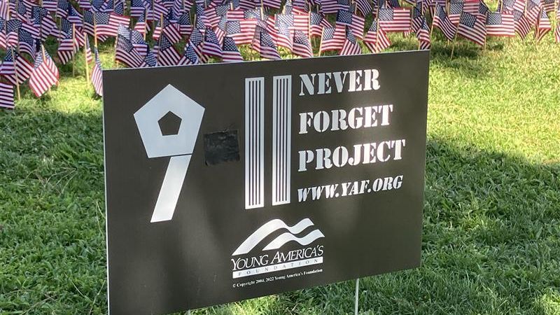 Black tape covers the image of a plane on a “9/11: Never Forget Project” sign at Fresno State after the design drew criticism on social media.