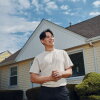 Francisco Vazquez, 27, stands in front of his new home in Milwaukee, Wis. He was able to buy it after changing his career track and saving aggressively, including for one year while he lived rent free with his parents.