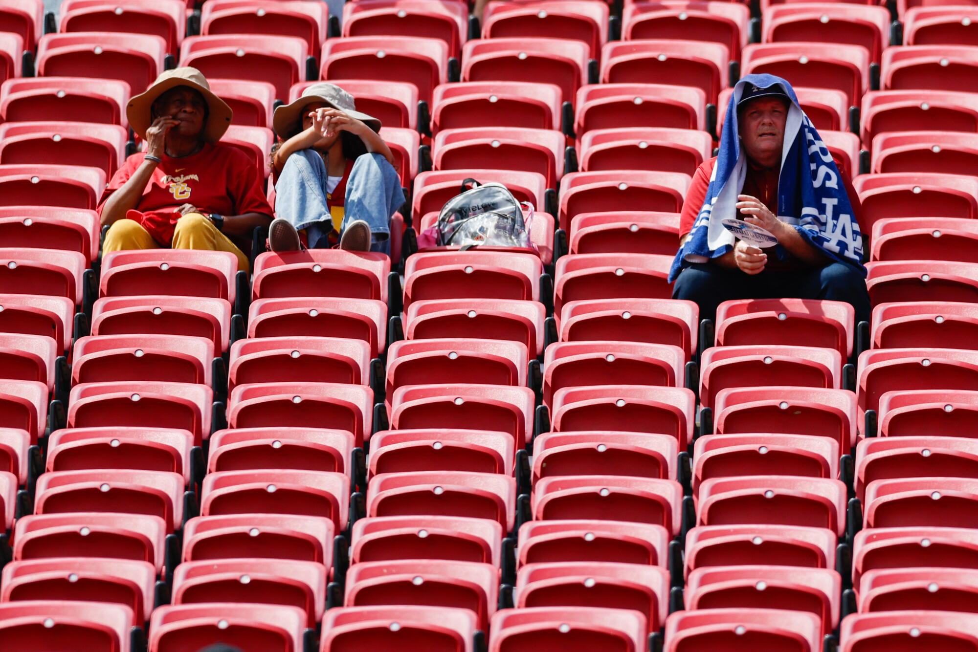 Fans wear big hats and blankets to dodge the sun before USC played San José State at the Coliseum on Saturday.