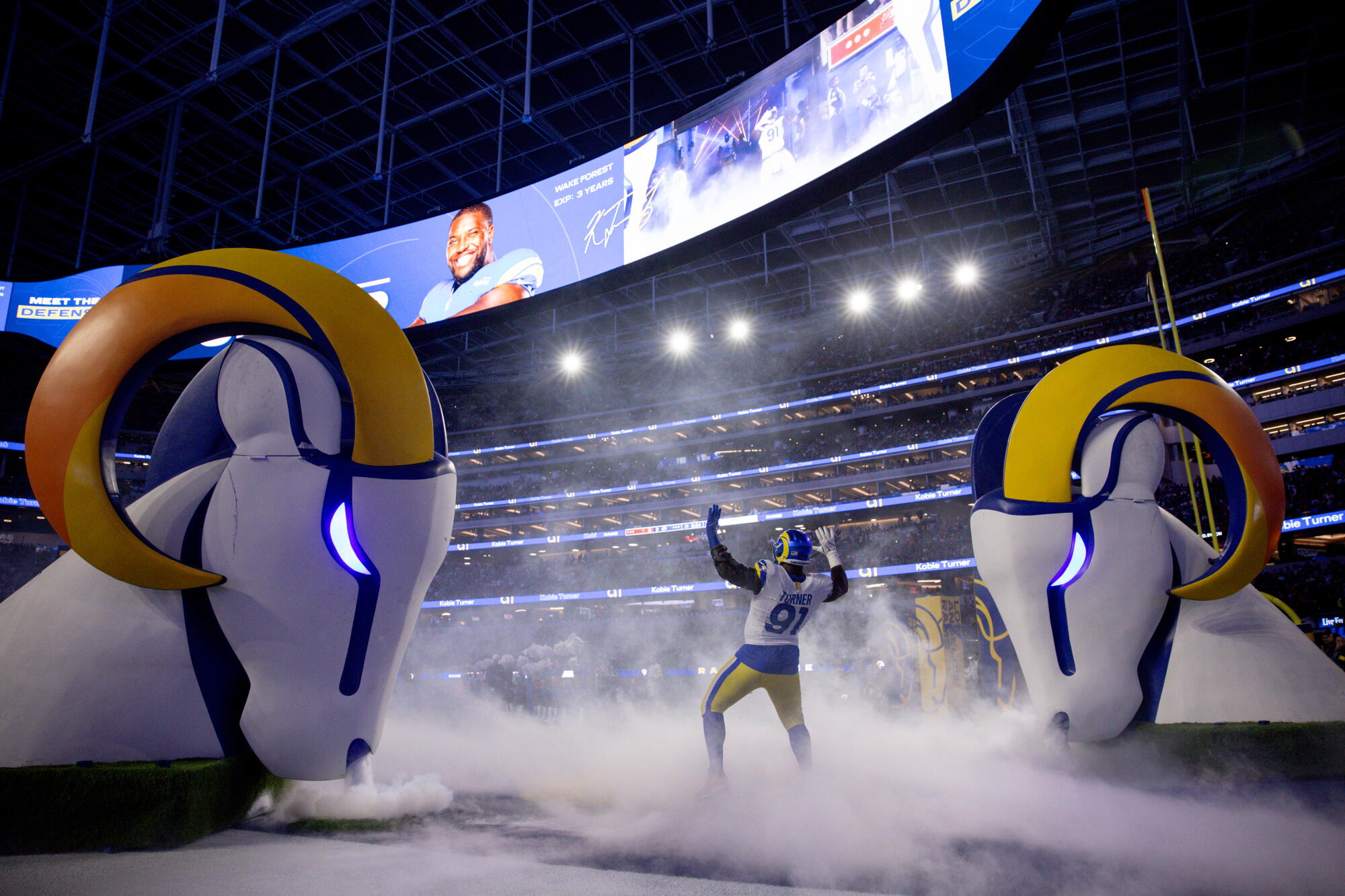 Rams defensive lineman Kobie Turner takes the field before a game at SoFi Stadium.