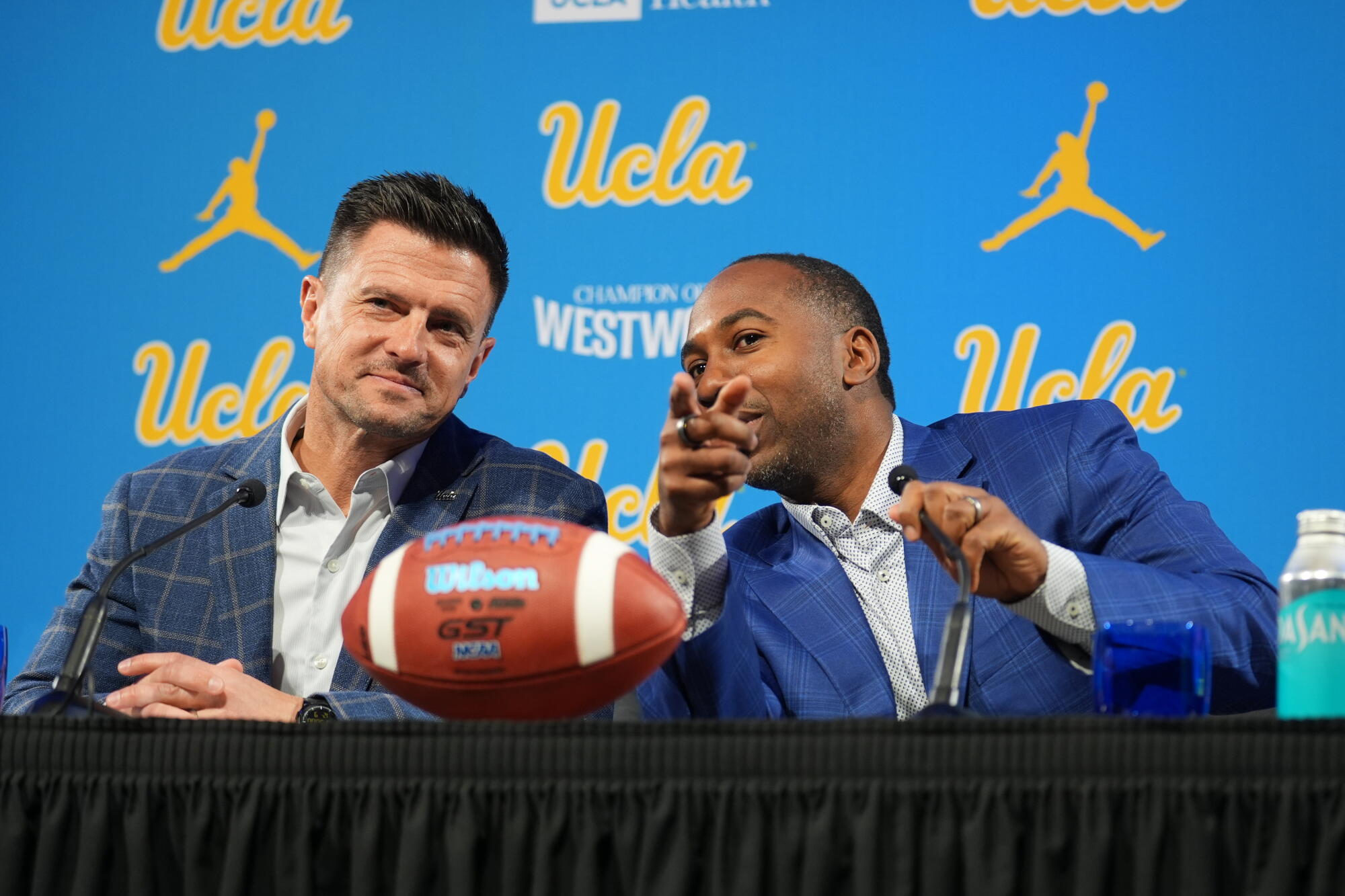 UCLA football coach Bob Chesney, left, sits next to UCLA athletic director Martin Jarmond.