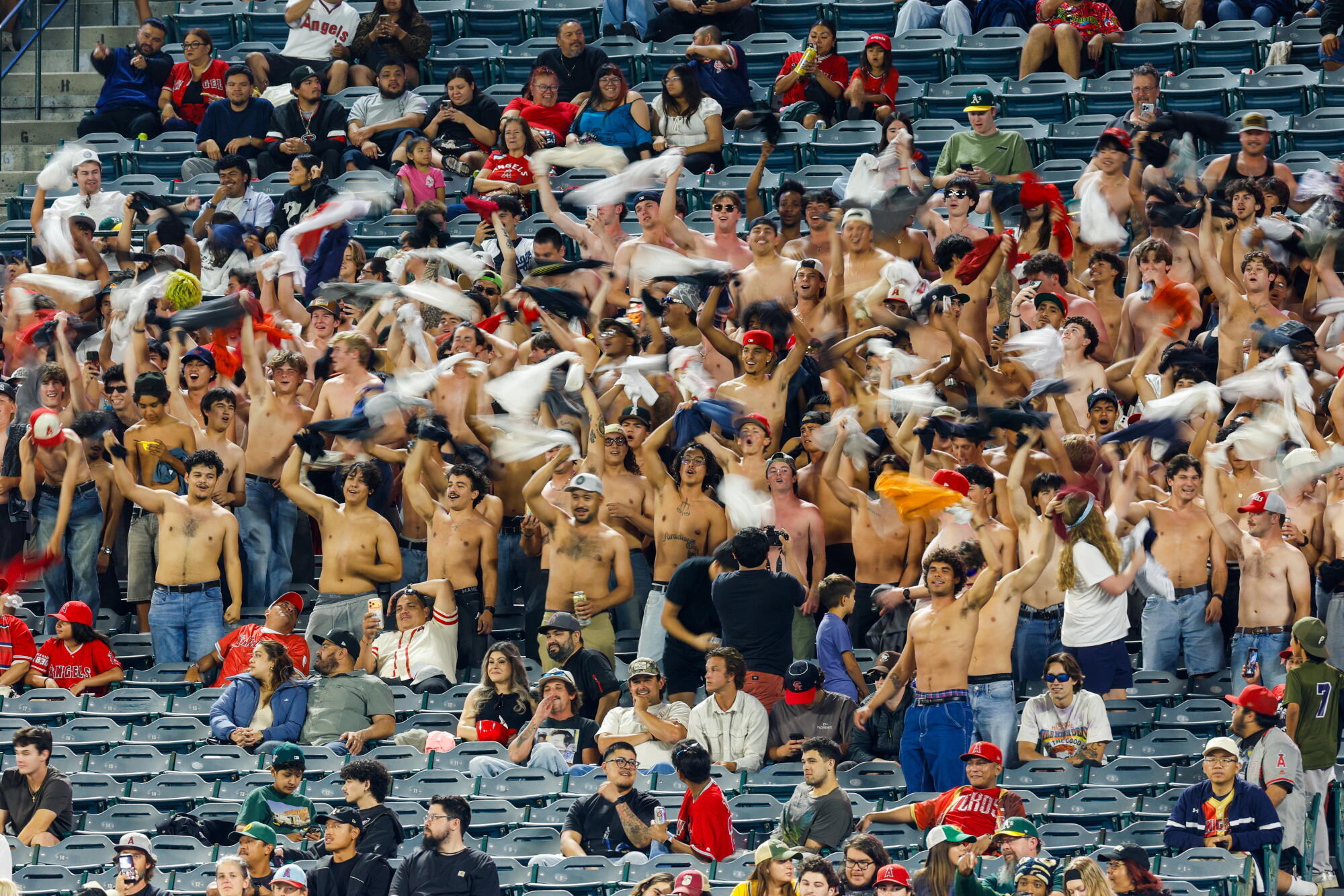 Angels fans wave their shirts and chant “sell the team” during the eighth inning of a game at Angel Stadium on May 20.