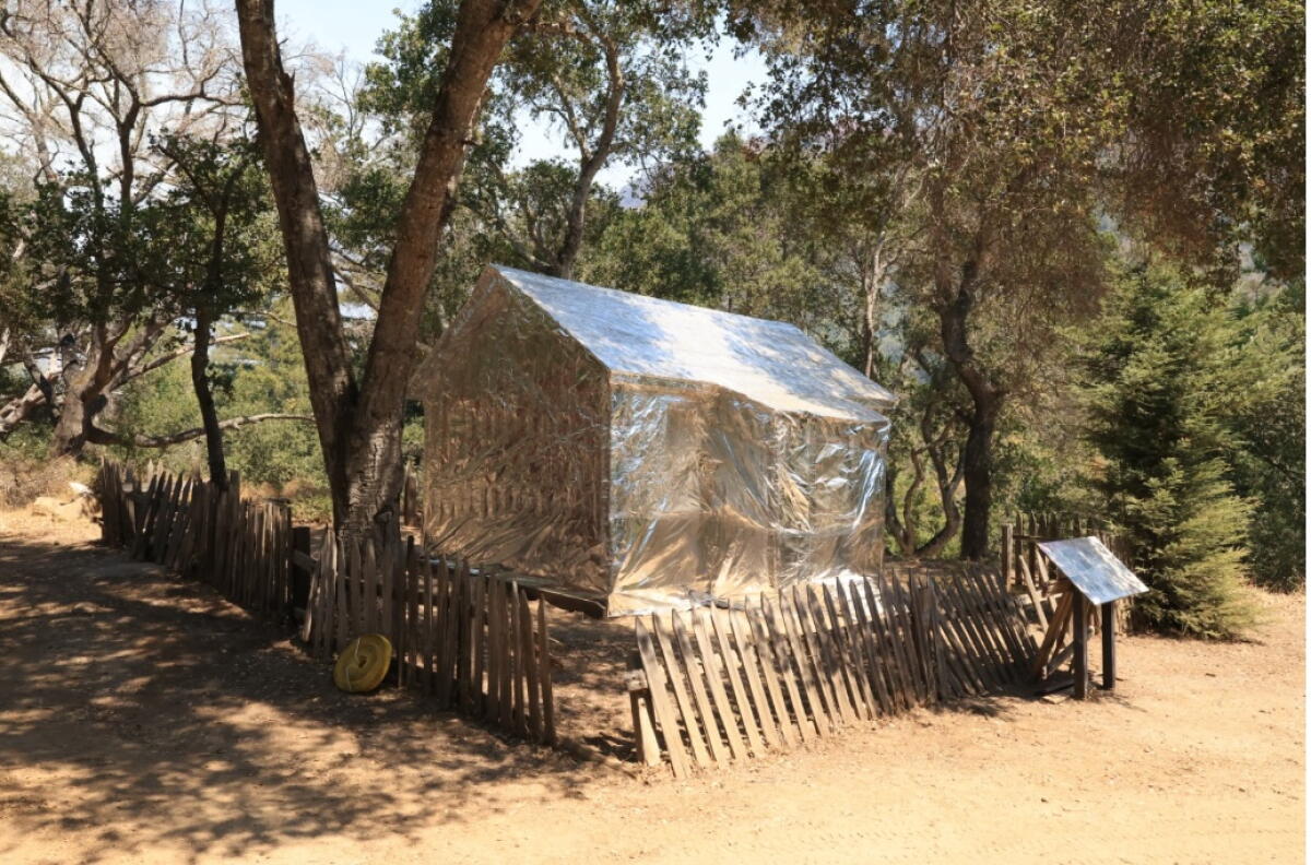 The 1884 Pfeiffer Homestead Cabin is wrapped in fire-resistant material as wildfires threaten in Big Sur.