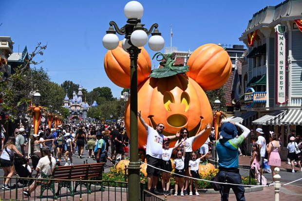 Visitors take a picture in front of a giant Mickey Mouse Jack-o'-lantern on Main Street, U.S.A, at Disneyland in Anaheim on Monday, August 17, 2026. (Photo by Jeff Gritchen, Orange County Register/SCNG)