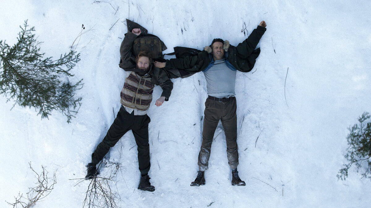 Ryan Reynolds and Kenneth Branagh make snow angels in "Mayday."