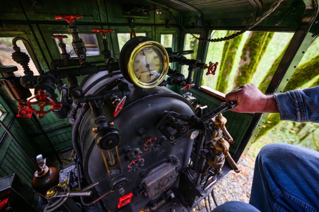 Engineer Dave Peterson keeps his hand on the throttle while operating the steam train at the Redwood Valley Railway at Tilden Regional Park in Orinda, Calif., on Monday, Aug. 31, 2026. Visitors are treated to a 12-15 minute ride on a 15-inch gauge track which was built back in 1952. (Jose Carlos Fajardo/Bay Area News Group)