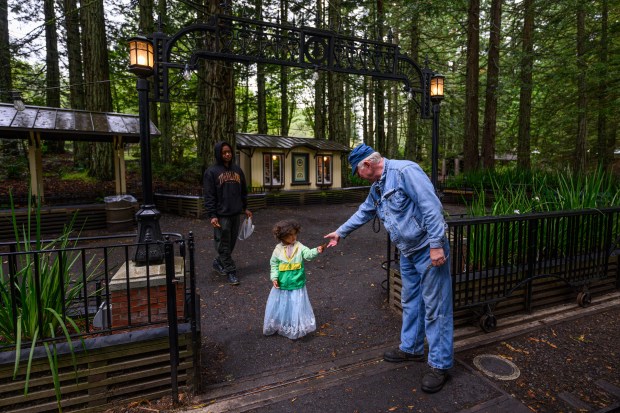 Jona Carson, 3, of Oakland, hands engineer Dave Peterson her ticket before riding steam train at the Redwood Valley Railway at Tilden Regional Park in Orinda, Calif., on Monday, Aug. 31, 2026. Visitors are treated to a 12-15 minute ride on a 15-inch gauge track which was built back in 1952. (Jose Carlos Fajardo/Bay Area News Group)