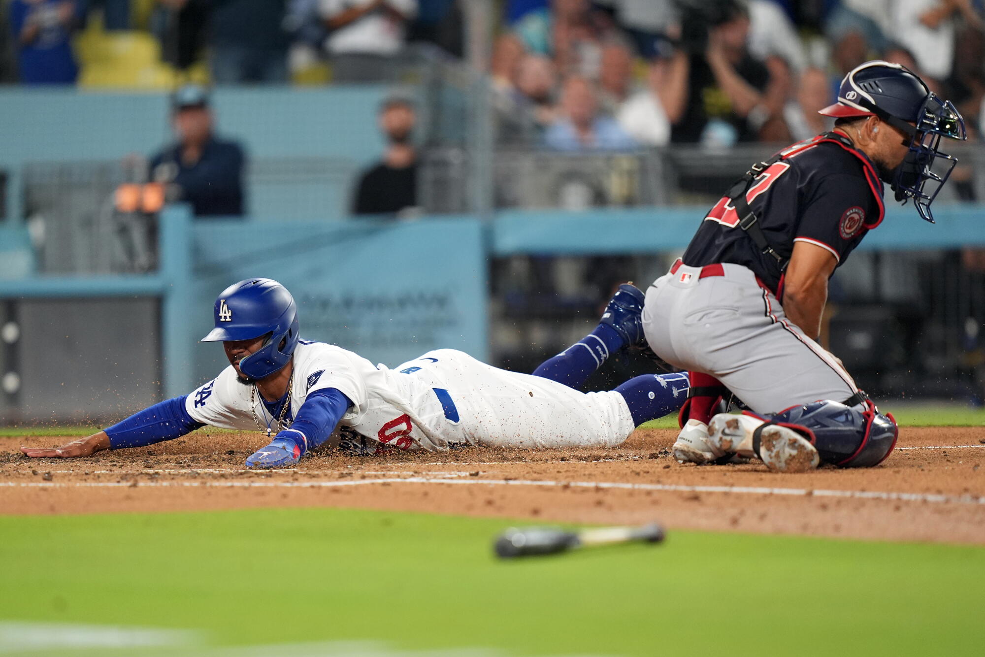 Mookie Betts scores on Teoscar Hernández's two-run double in the third inning against the Nationals on Friday.