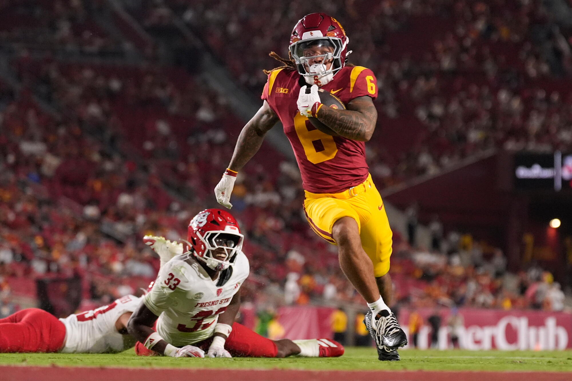 USC running back Deshonne Redeaux scores a touchdown after Fresno State defensive back Taylor Powell fails to tackle him.