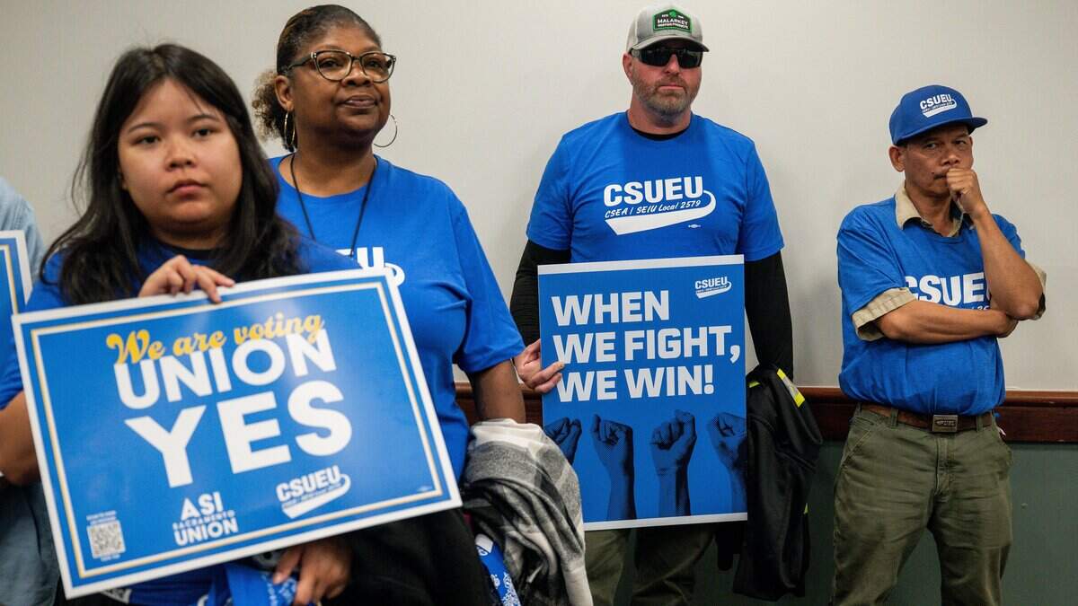 Members of California State University Employees Union hold signs during a group meeting following a bargaining session between the union and California State University at Sac State Student Union in Sacramento on Wednesday, Sept. 2, 2026.