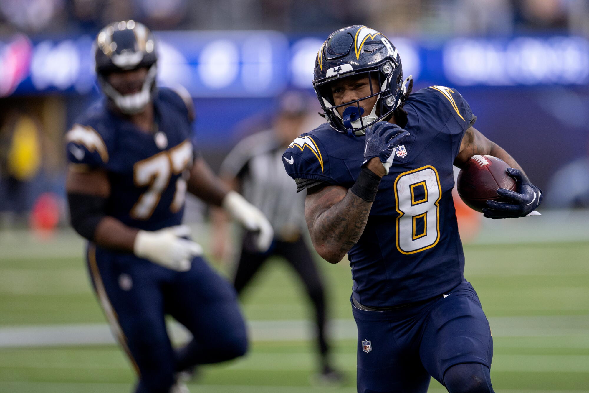Chargers running back Omarion Hampton carries the ball against the Houston Texans at SoFi Stadium.