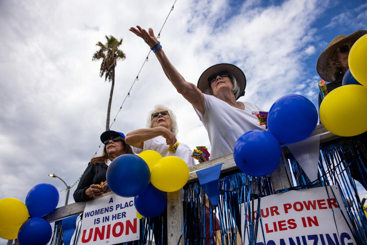 International Longshore and Warehouse Union members throw candy to onlookers at Monday's Labor Day parade.