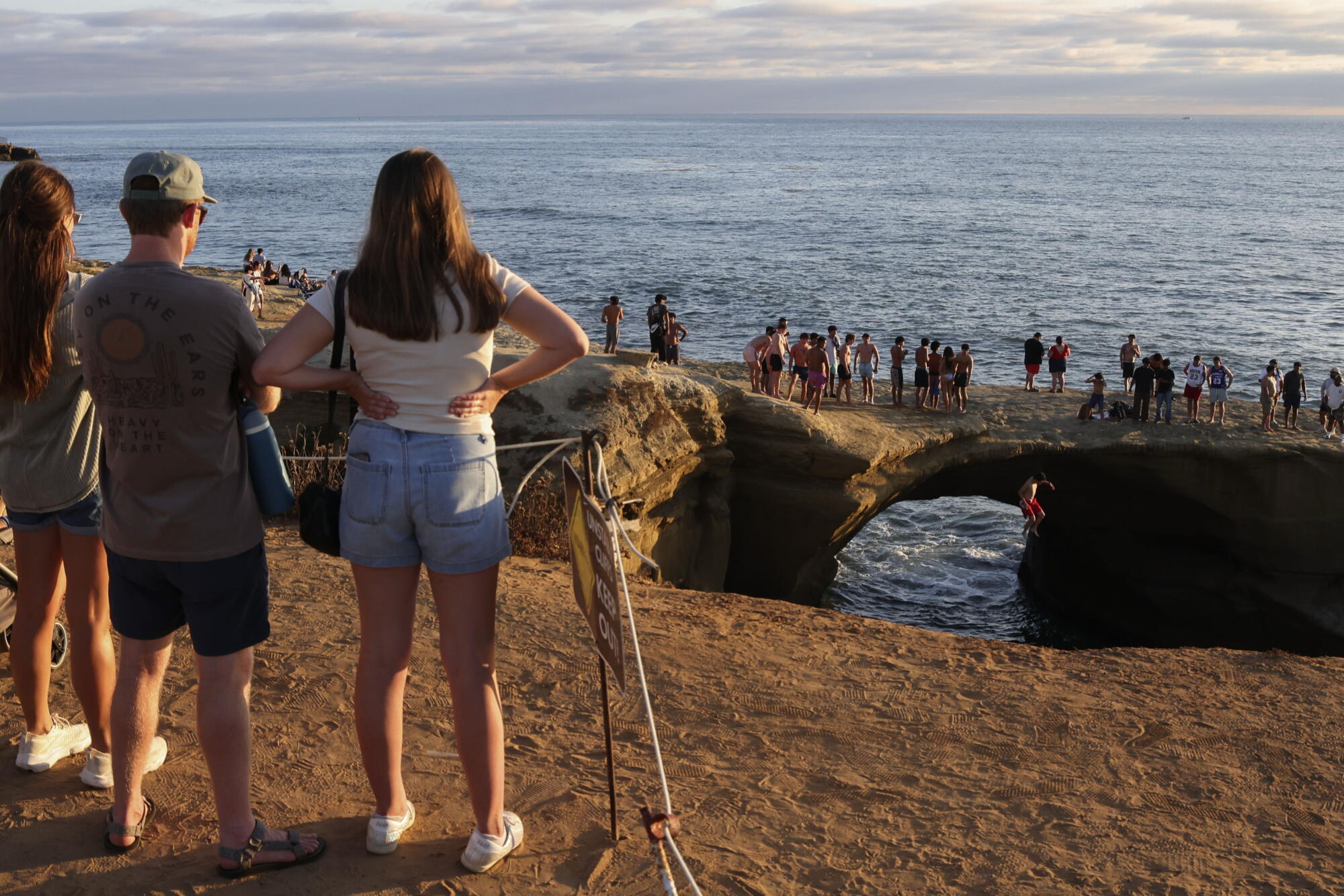 Spectators watch people jump into the water at Sunset Cliffs in the Ocean Beach area of San Diego on August 14.
