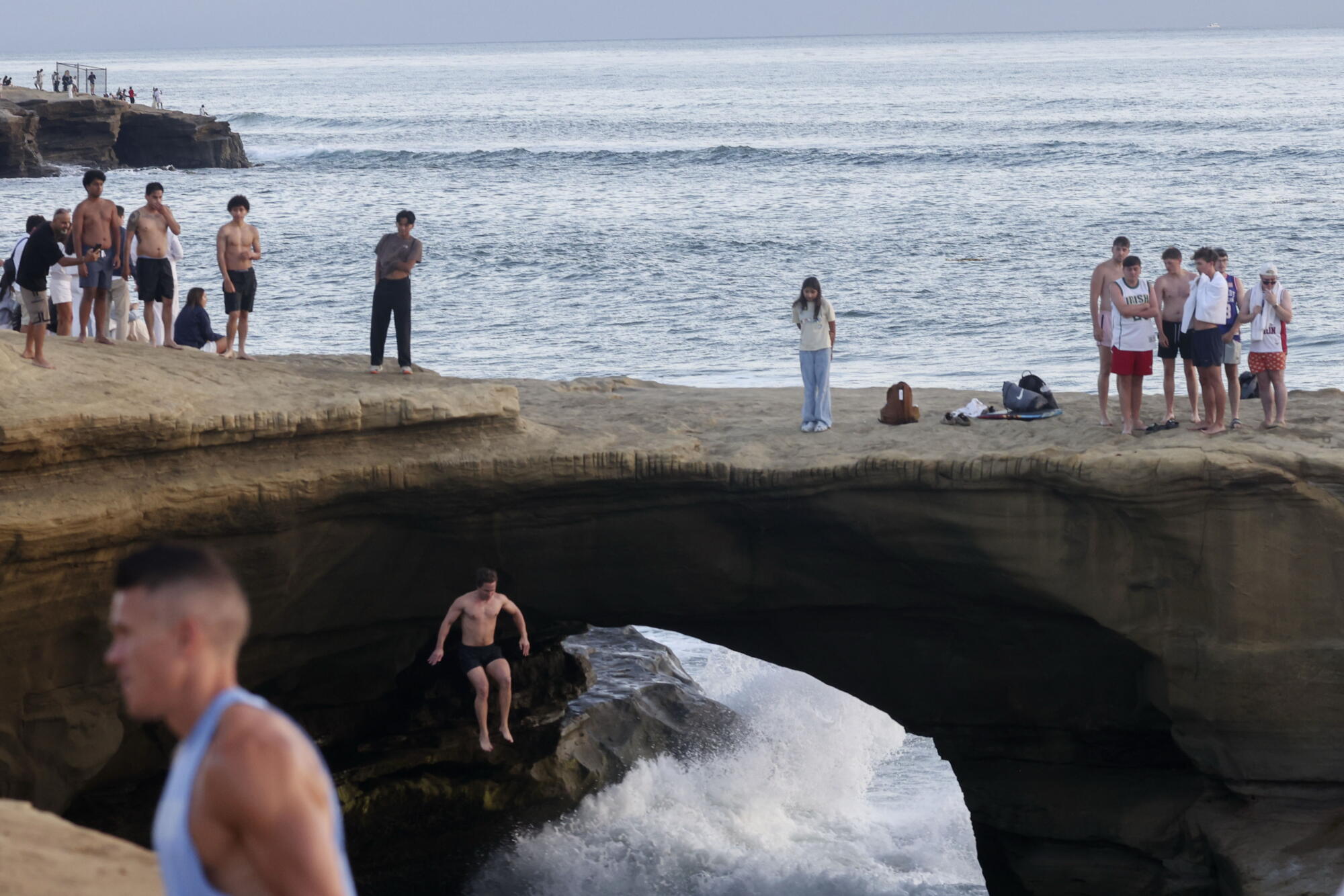 A jumper leaps into the water at Sunset Cliffs in the Ocean Beach area of San Diego on Aug. 14.