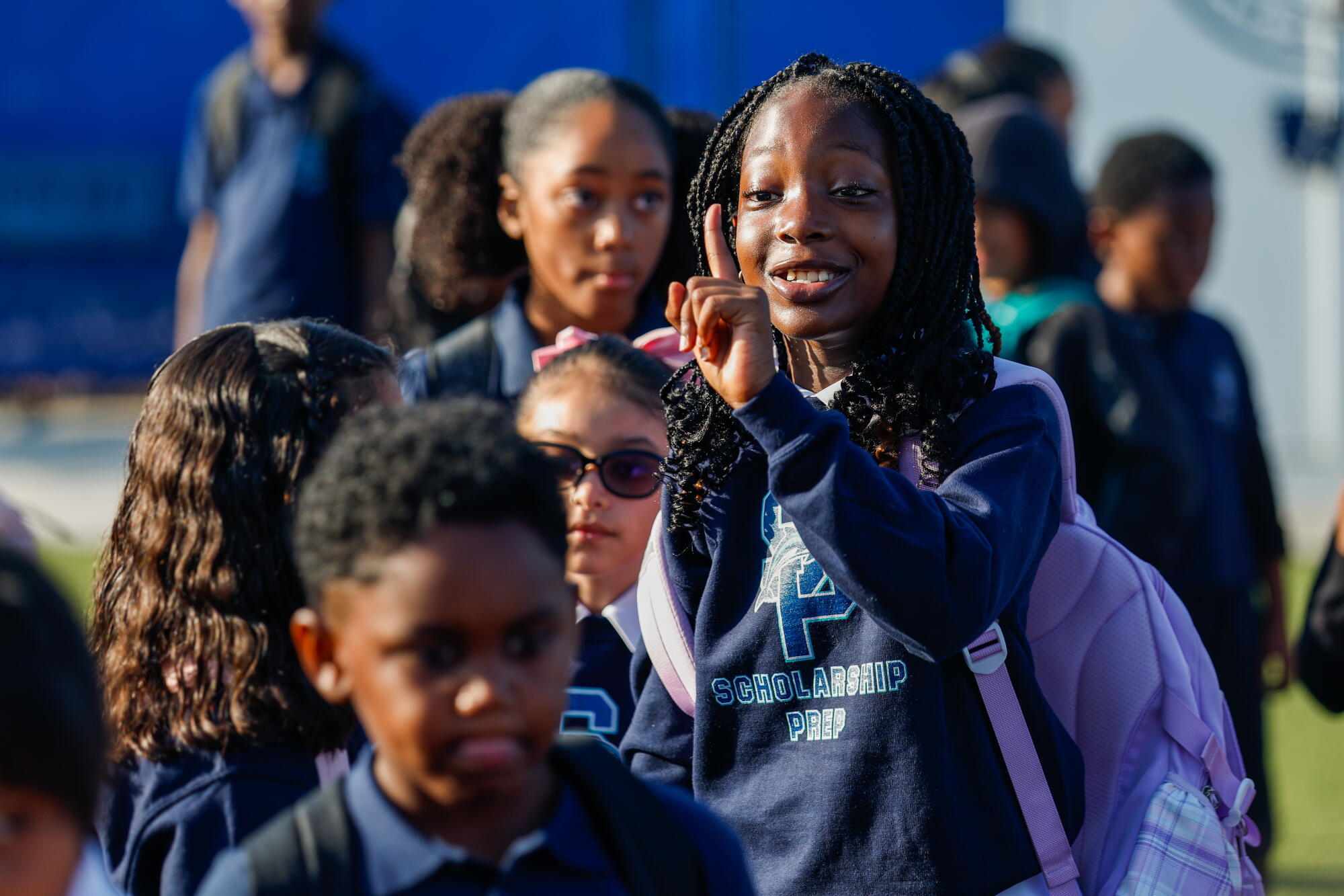Third-grader Oluwatamilore waits outside for the start of classes