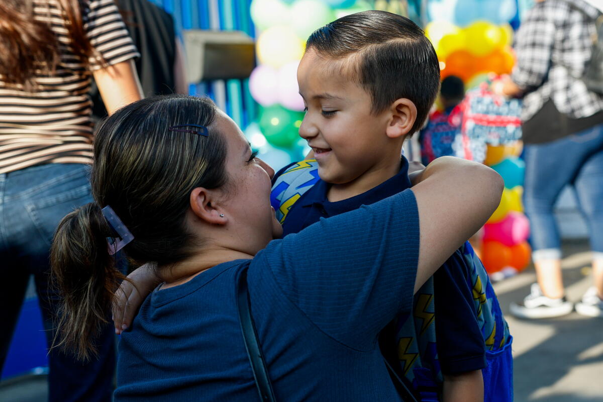 Wilmington resident Jessica Avalos, 29, says goodbye to her son Jaxson at the entrance of school