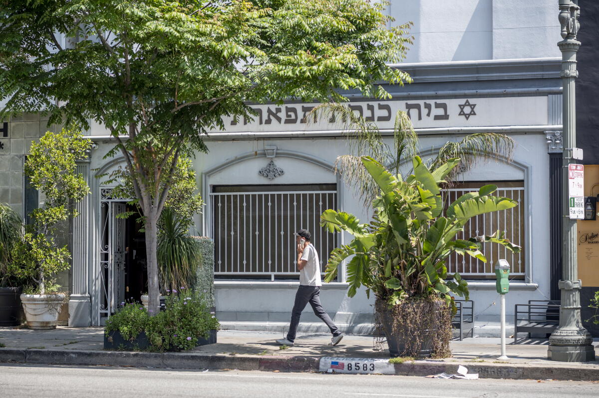 A person walks by a Jewish center in the Pico-Robertson neighborhood of Los Angeles