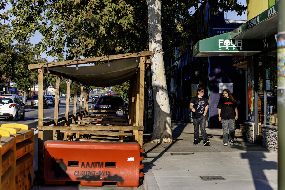 Passersby walk in front of shops on Colorado Boulevard in Eagle Rock. 