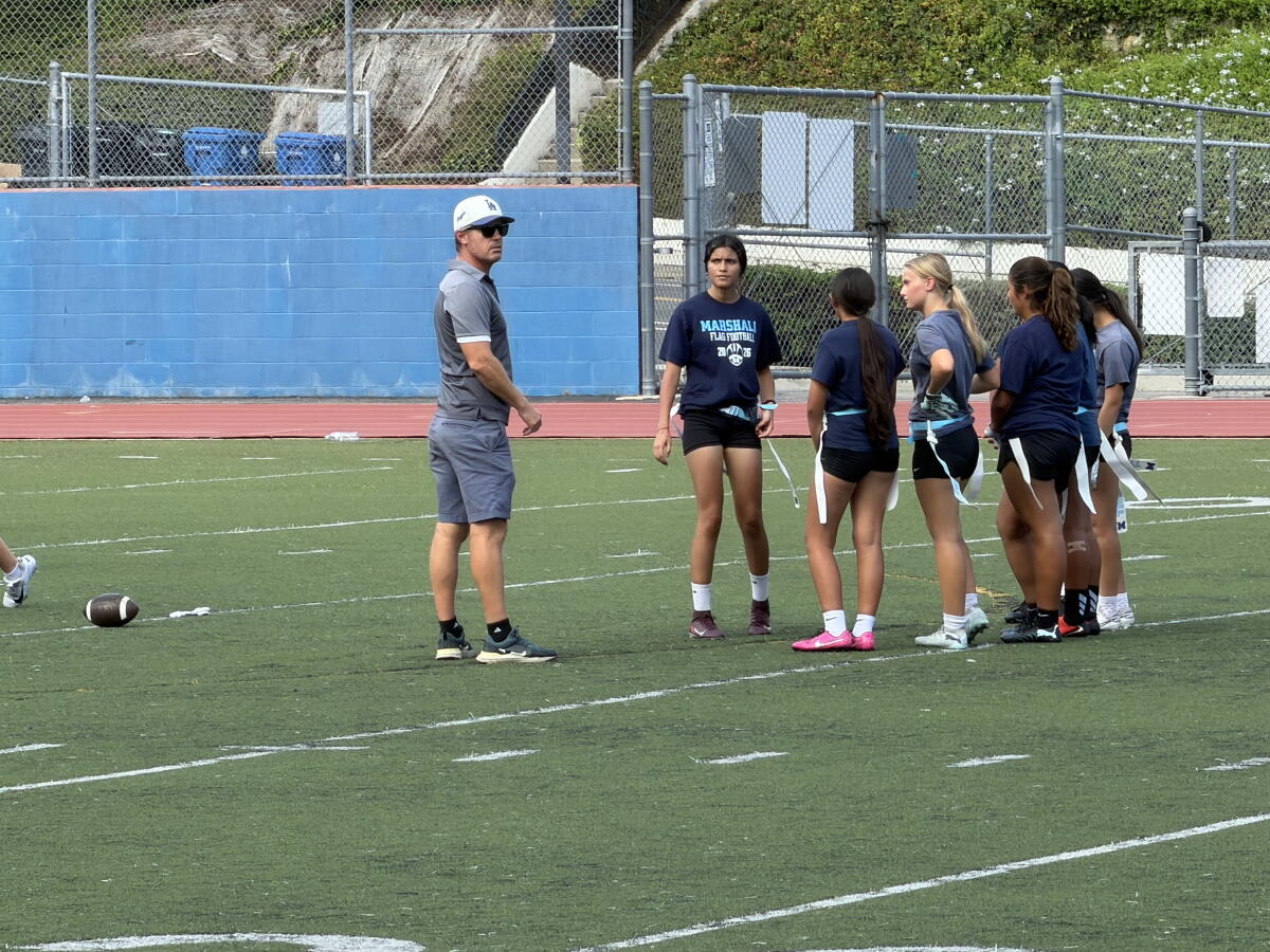 L.A. Marshall High flag football coach Shane Gerard huddles with his team.