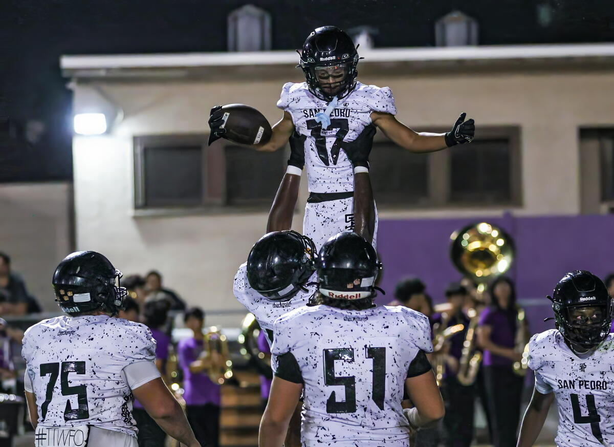 San Pedro players hoist Braeden Villegas after his touchdown reception against Bell.