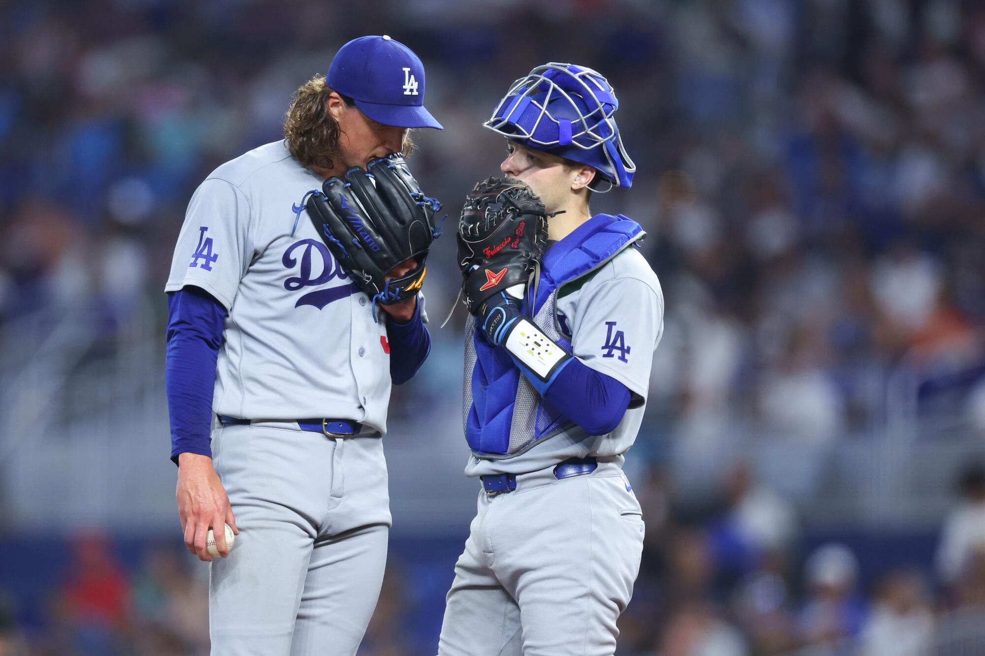 Dodgers pitcher Tyler Glasnow, left, talks with catcher Hunter Feduccia in the fifth inning Saturday against the Marlins.