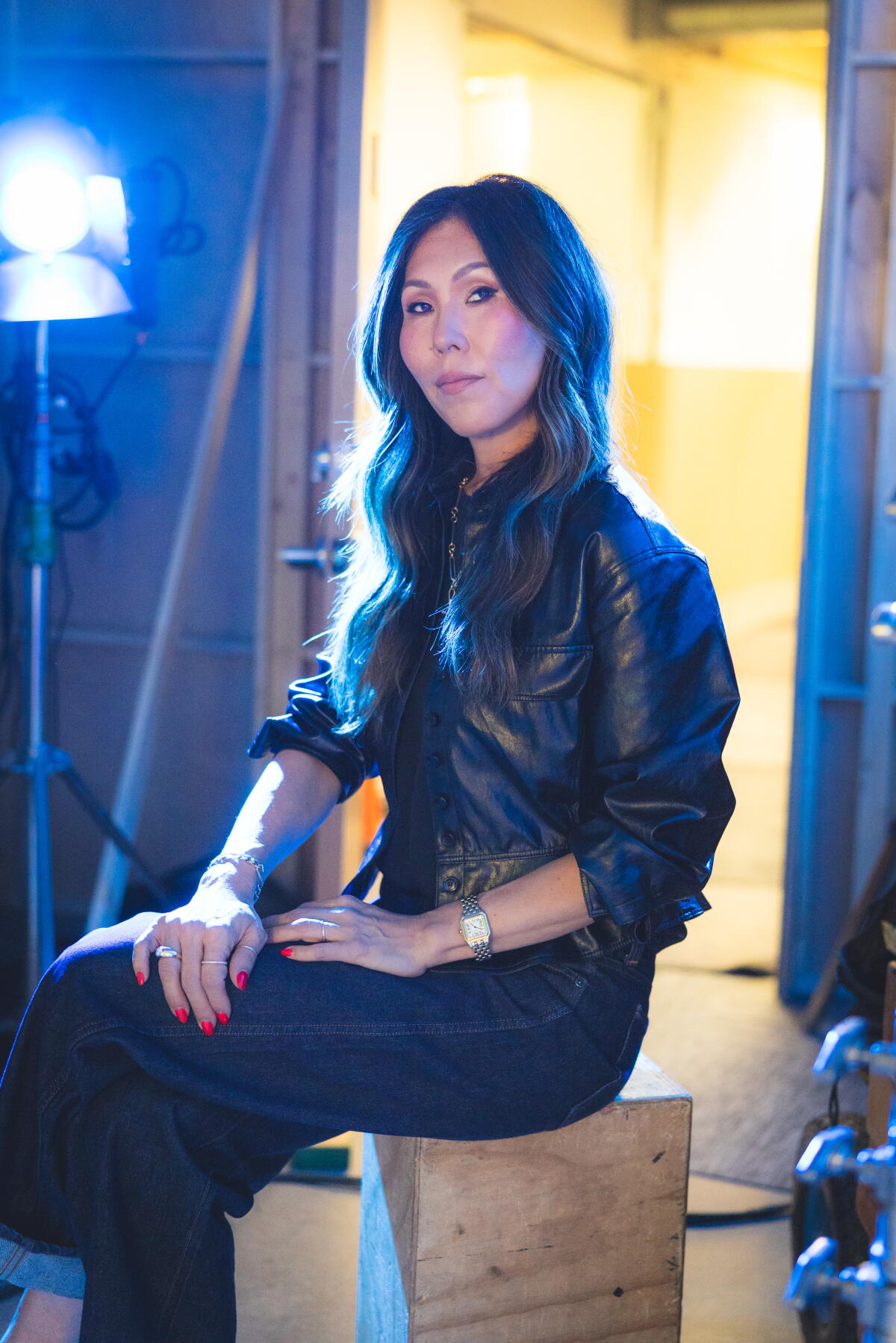 Jinny Howe seated near a studio light on the set of a Netflix series