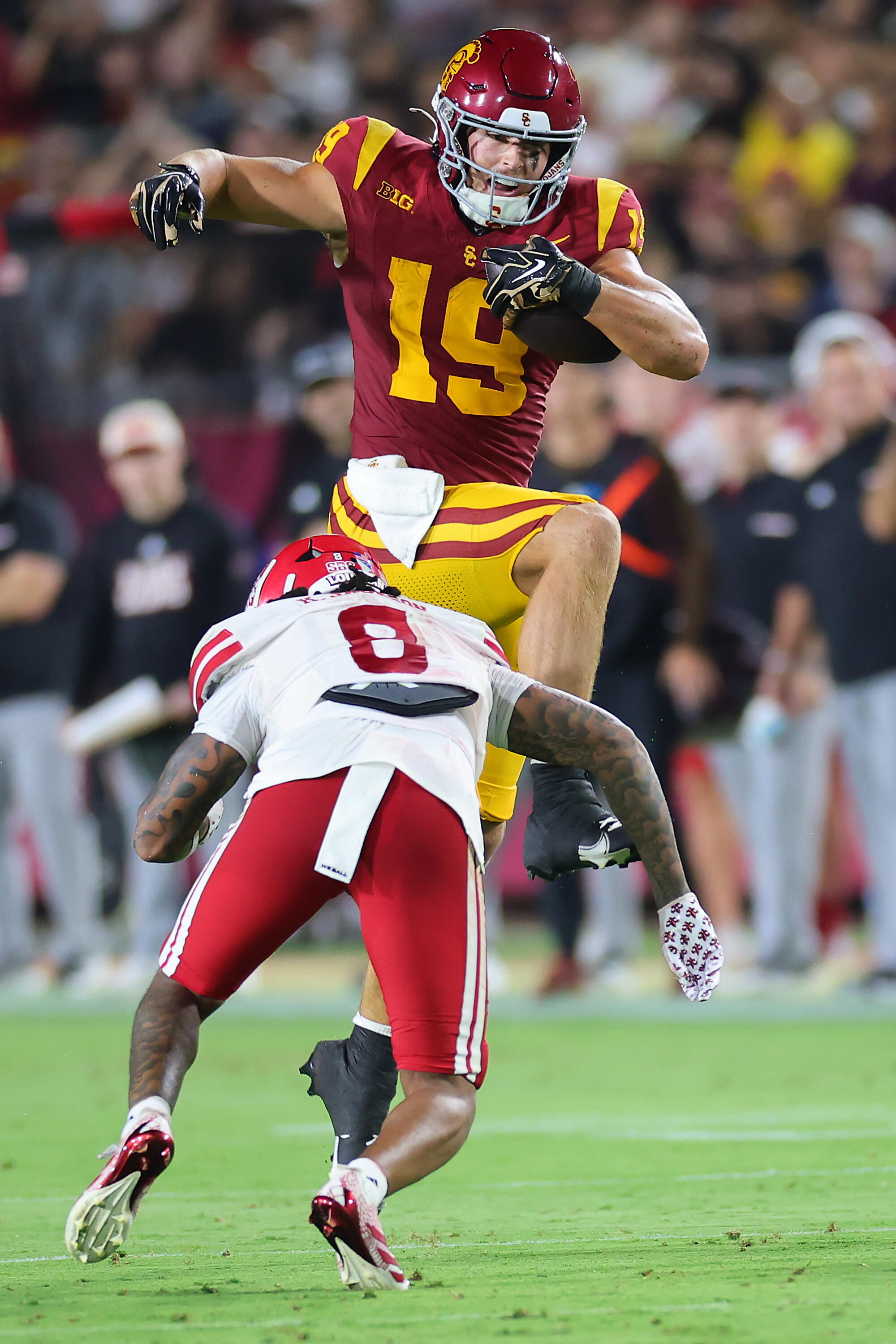 USC tight end Mark Bowman hurdles over Louisiana safety Kody Jackson.