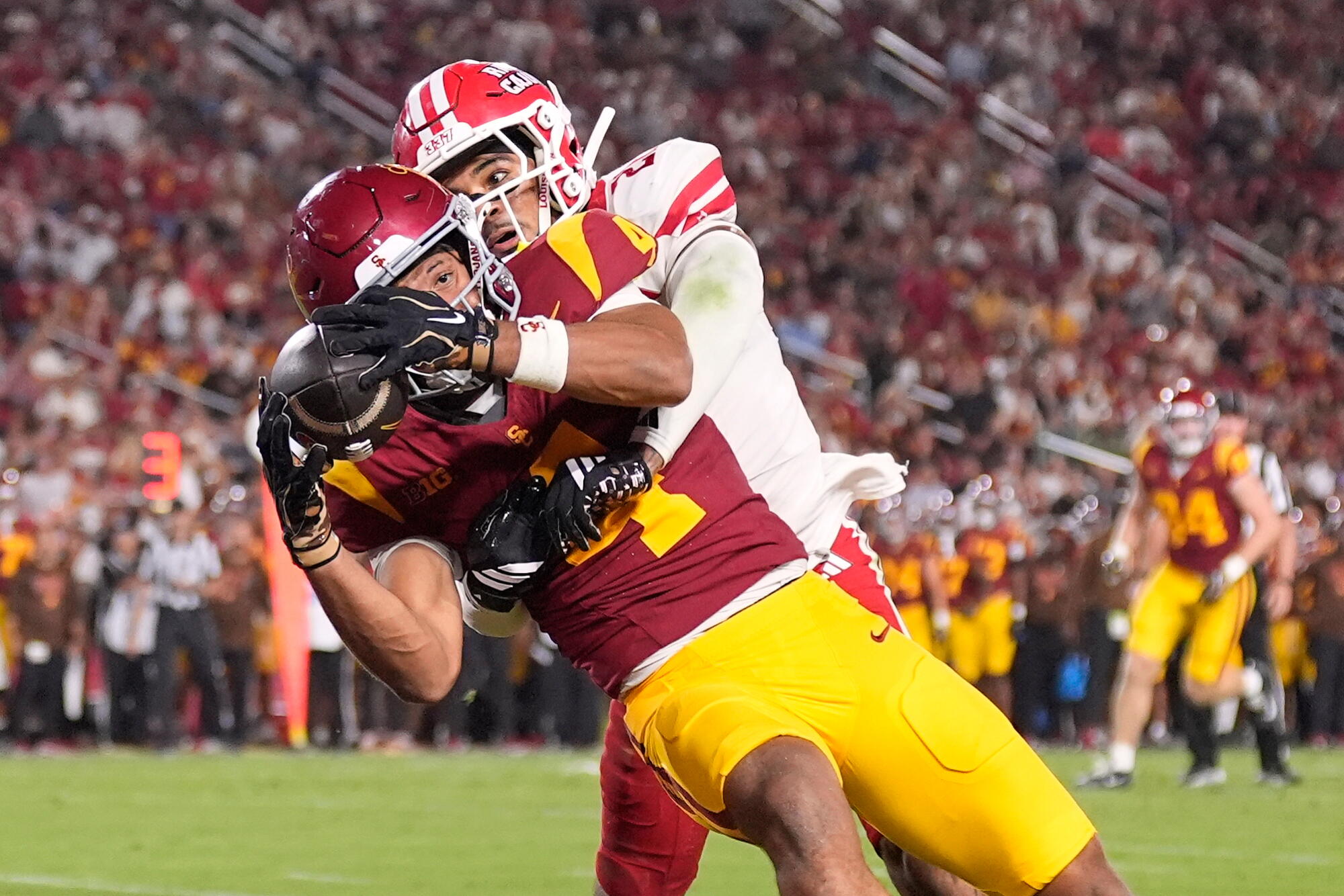 USC receiver Trent Mosley makes a touchdown catch under pressure from Louisiana safety Maurion Eleam Saturday.
