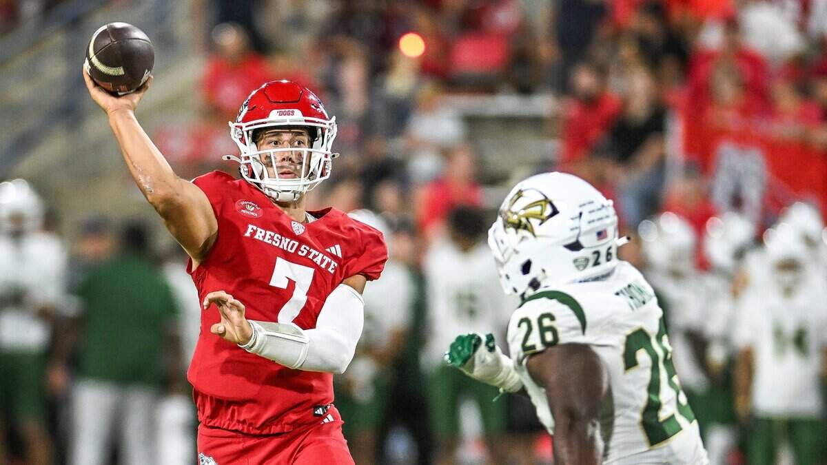 Fresno State quarterback Jayden Mandal throws for a 2-point conversion while getting pressure from Sacramento State's Tim Thomas in their game at Valley Children's Stadium in Fresno on Saturday, Sept. 12, 2026.