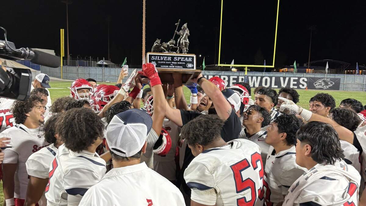 Sanger High holds the Silver Spear Trophy after a 42-20 victory over Clovis East on Friday, Sept. 11, 2026.