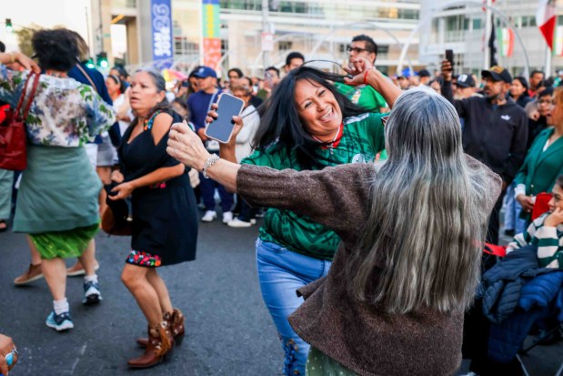 Hundreds of attendees dressed in patriotic colors and costumes dance Mexican music before "El Grito," or "The Cry," which would be delivered by Consul General Neftali Said Pérez González during the 216th anniversary of Mexican Independence Day celebrations at San Jose City Hall in San Jose, Calif., on Tuesday, Sept. 15, 2026. (Ray Chavez/Bay Area News Group)