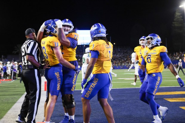 San Jose State Spartans' Cooper Hoch (13) celebrates scoring a touchdown with San Jose State Spartans' Lavaka Taukeiaho (72), San Jose State Spartans' Carson Clark (1), and San Jose State Spartans' Jabari Bates (6) against the Cal Poly Mustangs during the third quarter at CEFCU Stadium in San Jose, Calif., on Saturday, Sept. 12, 2026. (Shae Hammond/Bay Area News Group)