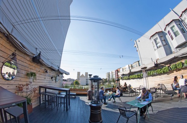 Customers enjoy a sunny day in Old Oakland on the rooftop dining area at Oeste on Aug. 27, 2020. (Doug Duran/Bay Area News Group)