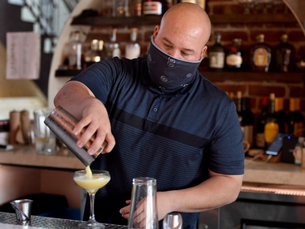 A bartender at Oeste in Oakland makes a Mockingbird Cocktail on Aug. 27, 2020. (Doug Duran/Bay Area News Group)