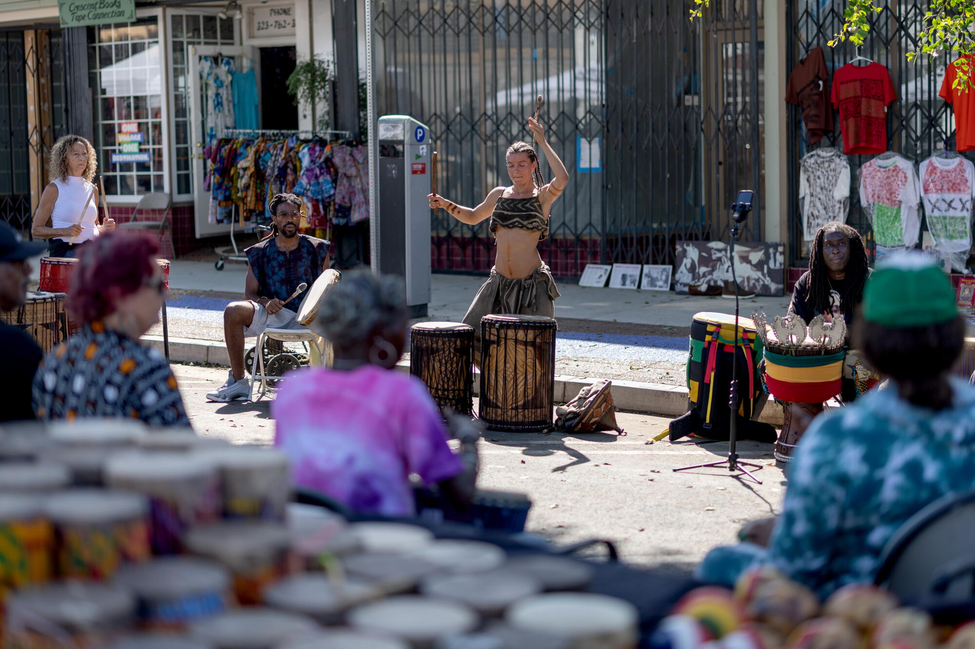 People take part in a drum circle at at weekly market in the Leimert Park neighborhood.