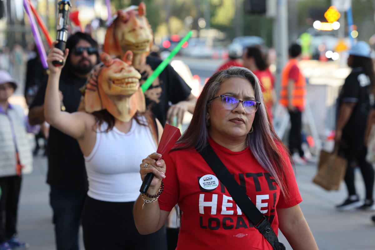 Gladys Avyla marches in a No Games Coalition protest outside The Lucas Museum of Narrative Art 
