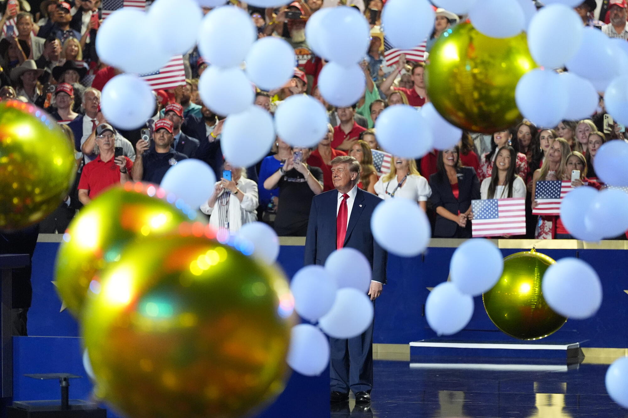 President Donald Trump watches as balloons fall at the Republican convention