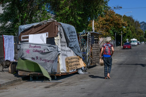 An unhoused person walks along Harrison street after the city of Berkeley dismantled a homeless encampment near the corner of 8th Street and Harrison Street in Berkeley, Calif., on Friday, Sept. 18, 2026. (Jose Carlos Fajardo/Bay Area News Group)