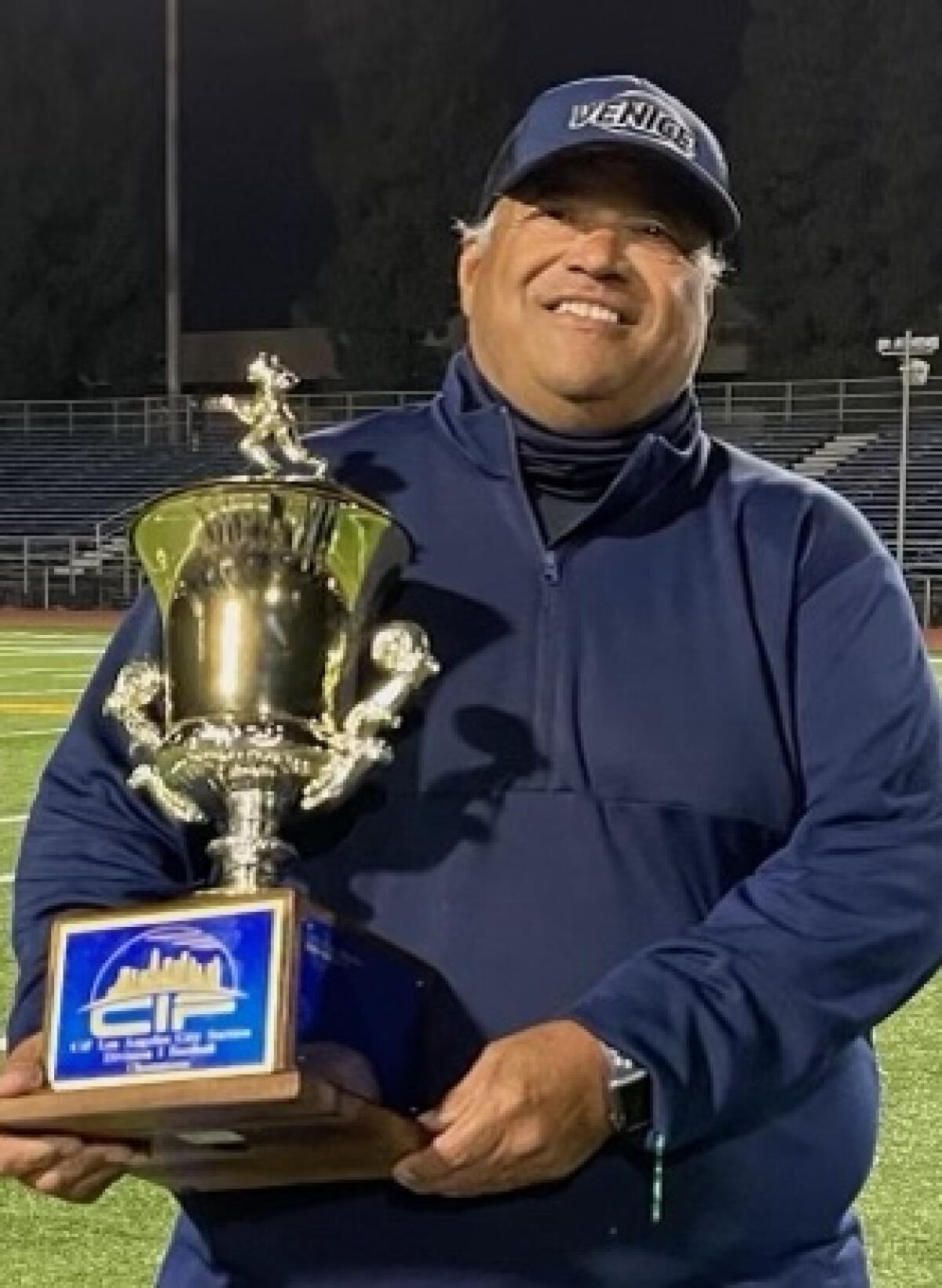 Venice coach Angelo Gasca showing off the City Division I title trophy in 2021.