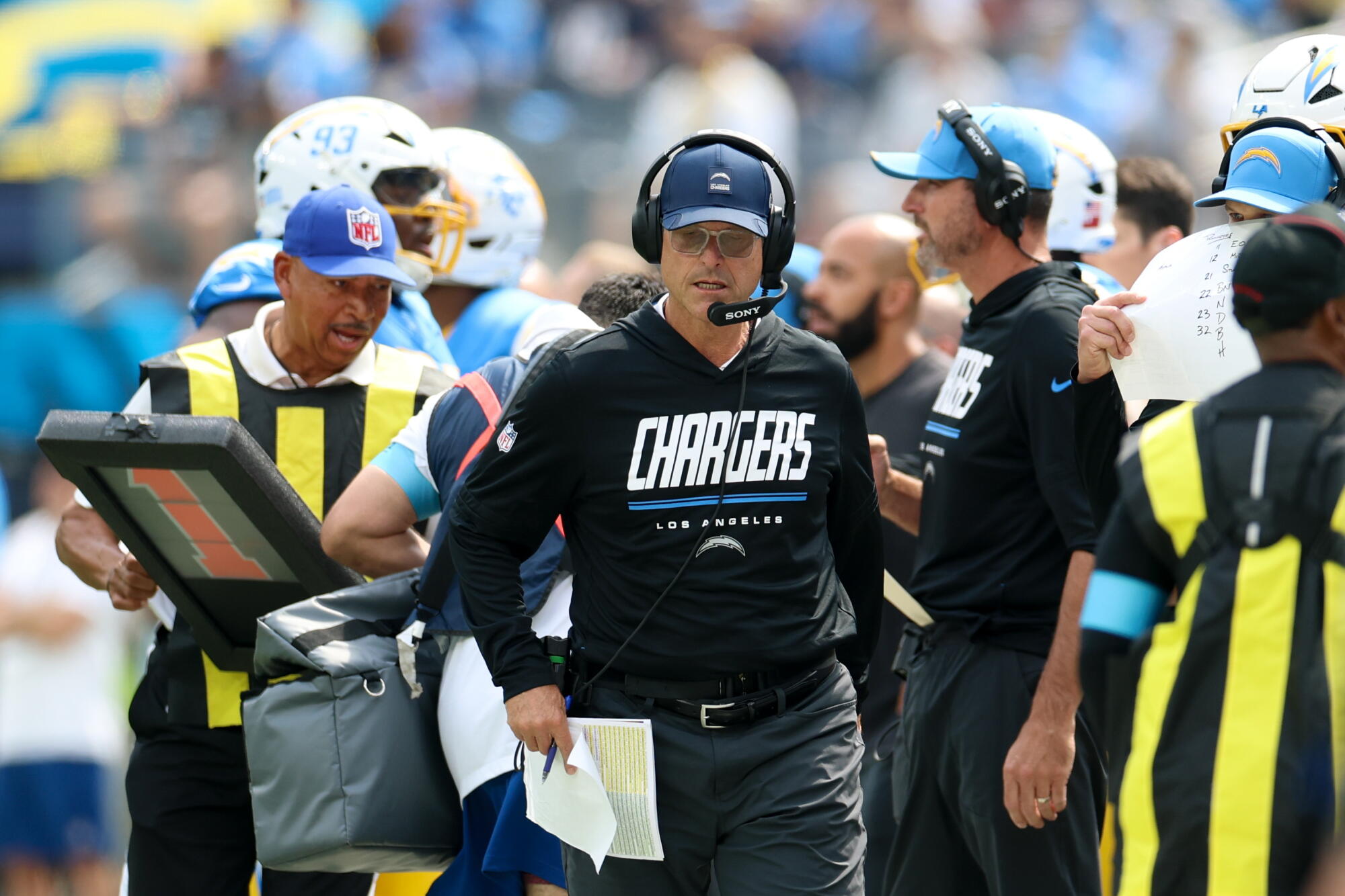 Chargers coach Jim Harbaugh walks on the sideline during the first quarter Sunday.