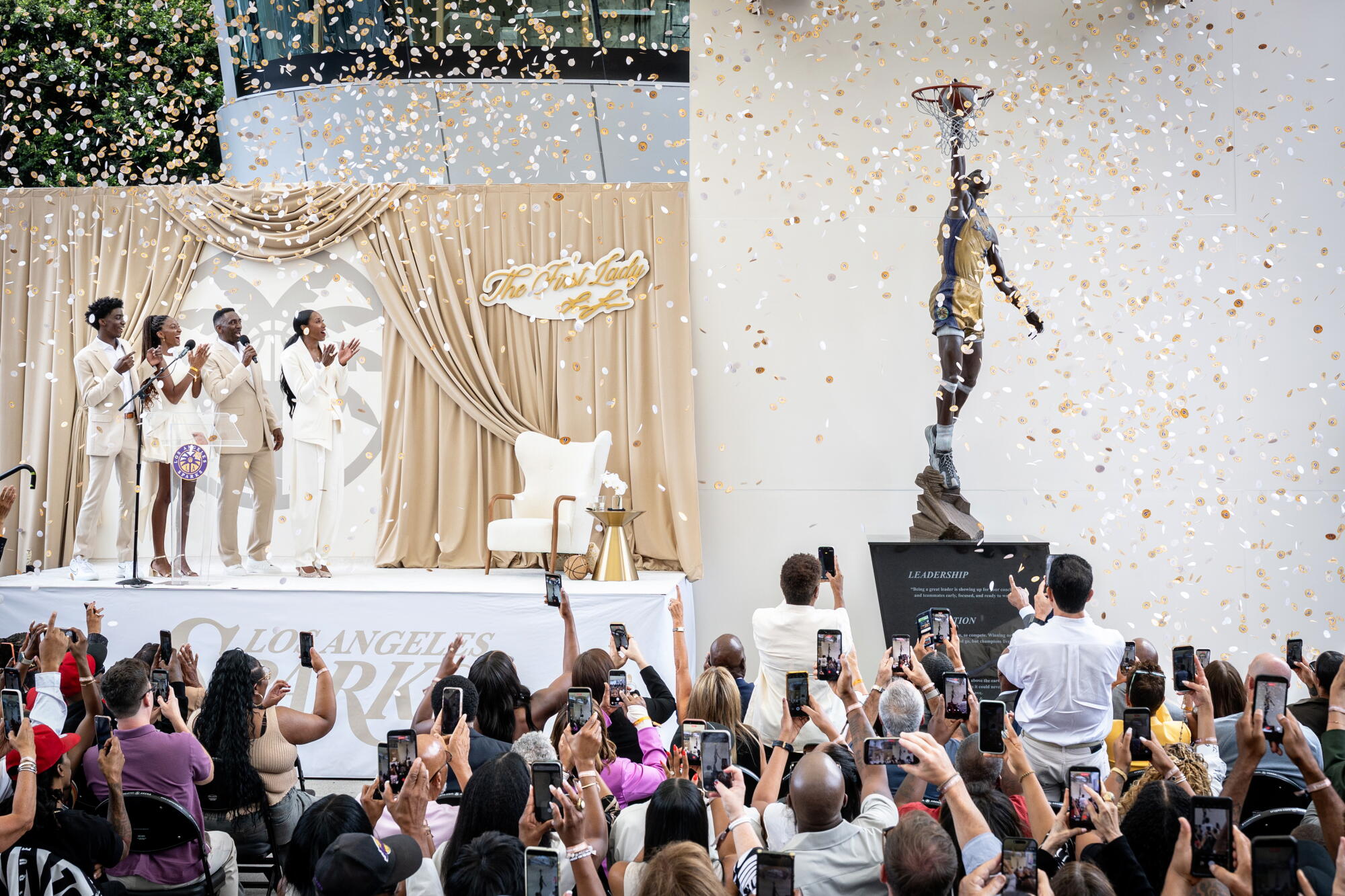 Lisa Leslie and her family celebrate onstage as her statue is revealed and confetti fall