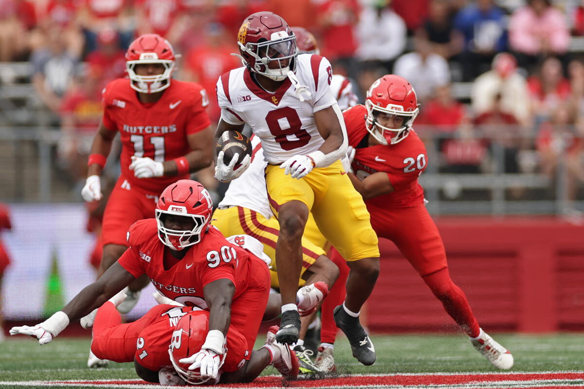 King Miller runs past Rutgers defensive lineman Farell Gnago in the first half.