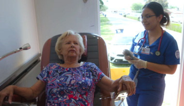 A Fresno State nursing student checks a patient’s vital signs inside a mobile health unit.