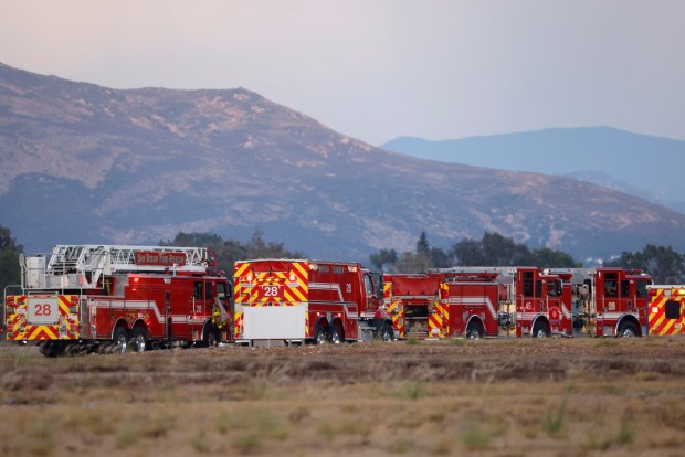 San Diego Fire-Rescue engines park on scene of a fatal airplane crash at Montgomery-Gibbs Executive Airport in Kearny Mesa on Sept. 7, 2026. (K.C. Alfred / The San Diego Union-Tribune)
