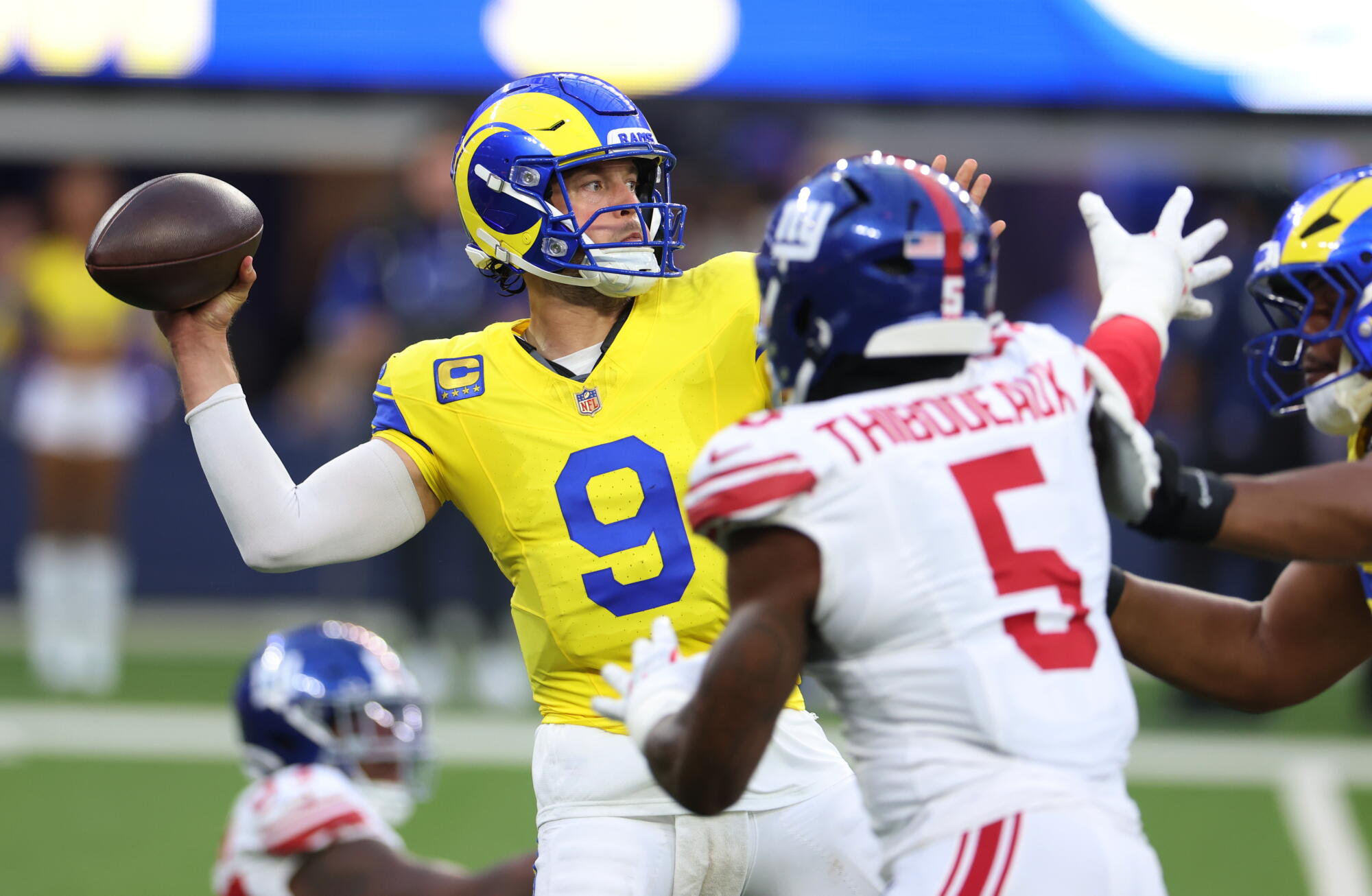 Rams quarterback Matthew Stafford passes under pressure in the first half against the Giants.